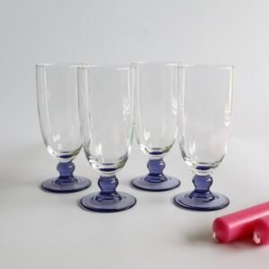 Set van vier Luminarc France champagnefluiten met paarse glazen voet en helder glas.